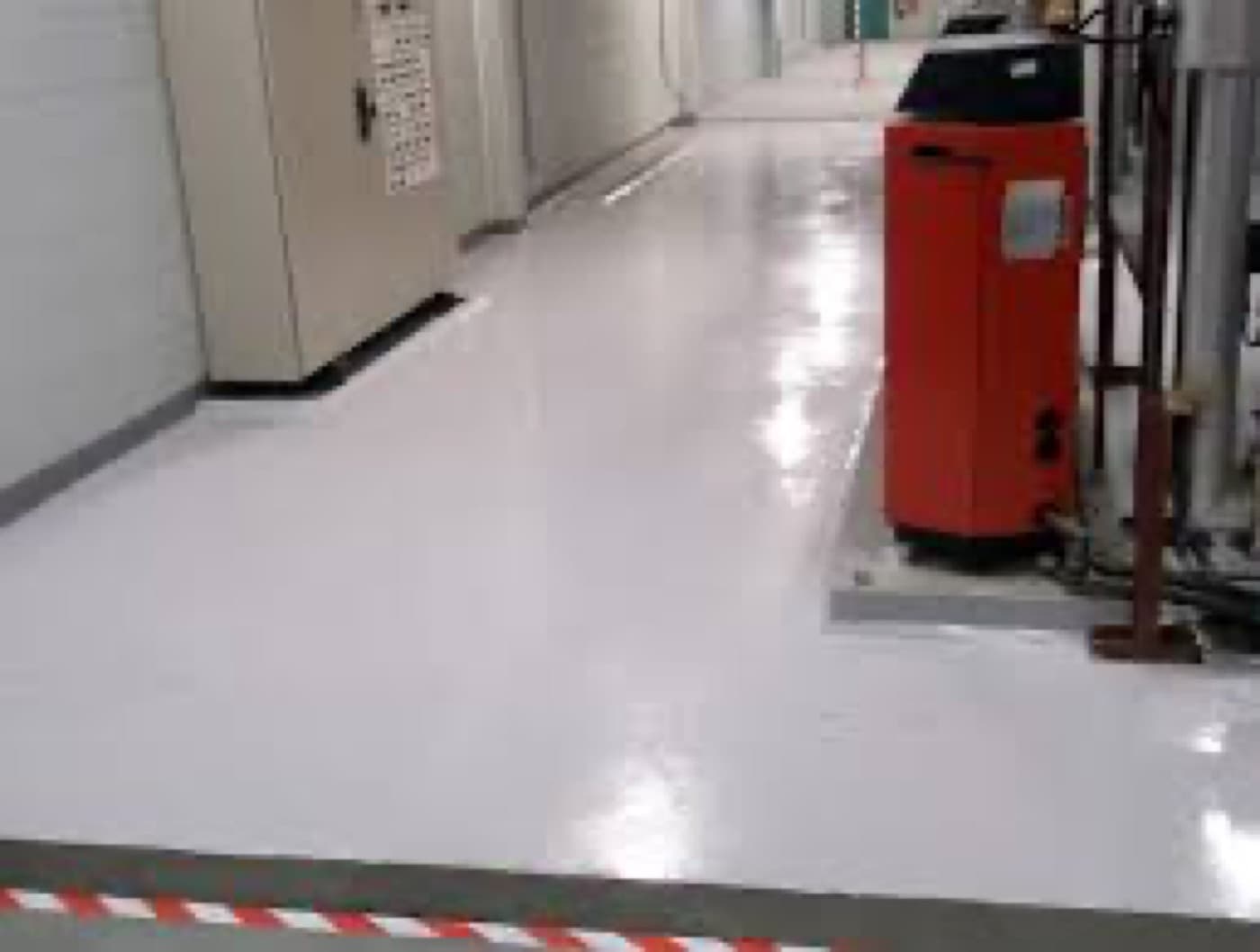 Chemical-resistant floor system laid over a rebuilt process slab.