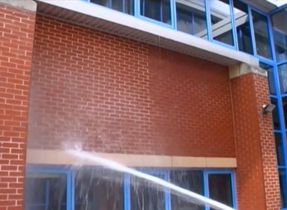 Demonstration of the water-repellent properties of Belzona 5122 (Clear Cladding Concentrate) on the left side of the wall
