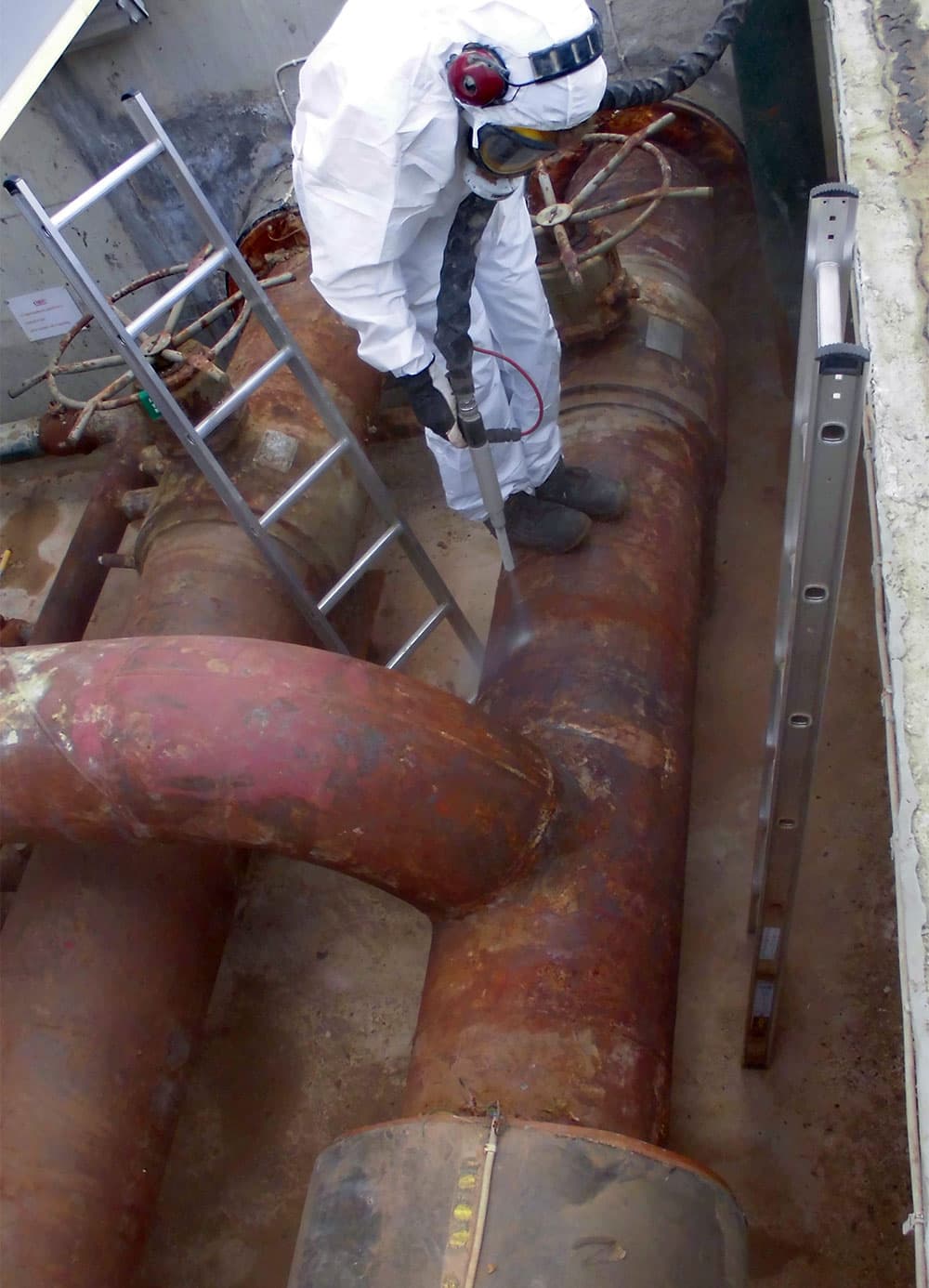 Surface preparation on live equipment in progress