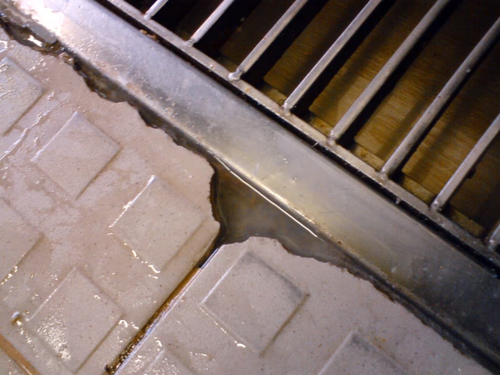Leaking floor drain around grating seat